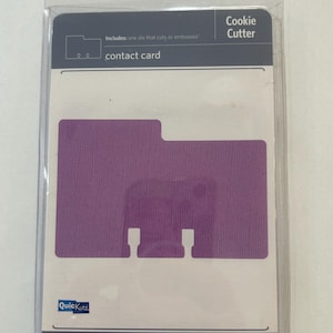 May include: A cookie cutter in a clear plastic package. The package includes a purple contact card die. The text on the package reads "Cookie Cutter" and "contact card". The brand name "Quickutz" is also visible.