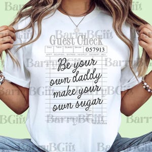 May include: White t-shirt with a guest check design and the phrase "Be your own daddy make your own sugar." The shirt has a date, table, and server section, and the number 057913.