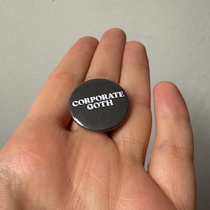 Corporate goth: pin back button badge.