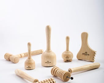 May include: A set of wooden massage tools, including a roller, a hammer, and a comb. The tools are made of natural wood and have the brand name "palmarosa" printed on them.