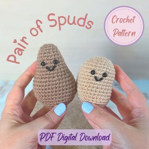 May include: Two crocheted potato-shaped figures with smiling faces. One is light brown, the other is a darker brown. Text reads "Pair of Spuds" and "Crochet Pattern". The words "PDF Digital Download" are also visible.