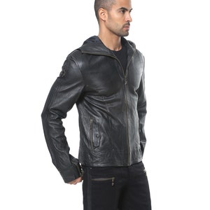 May include: A black leather jacket with a zipper closure and a hood. The jacket has a distressed look and features multiple pockets.