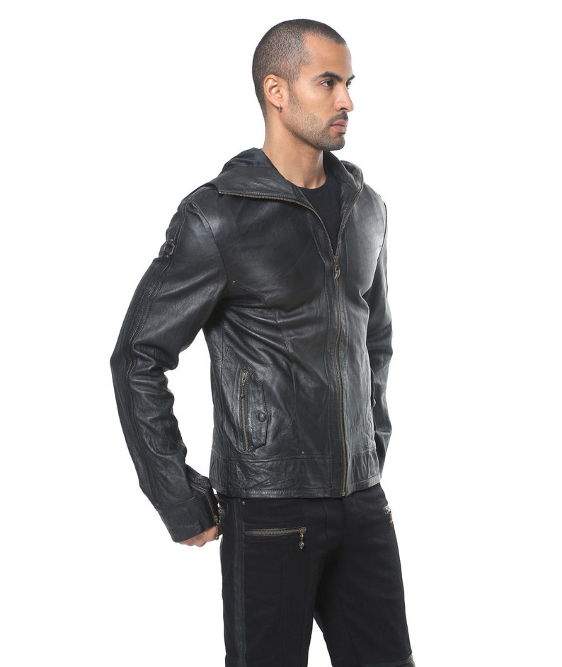 May include: A black leather jacket with a zipper closure and a hood. The jacket has a distressed look and features multiple pockets.