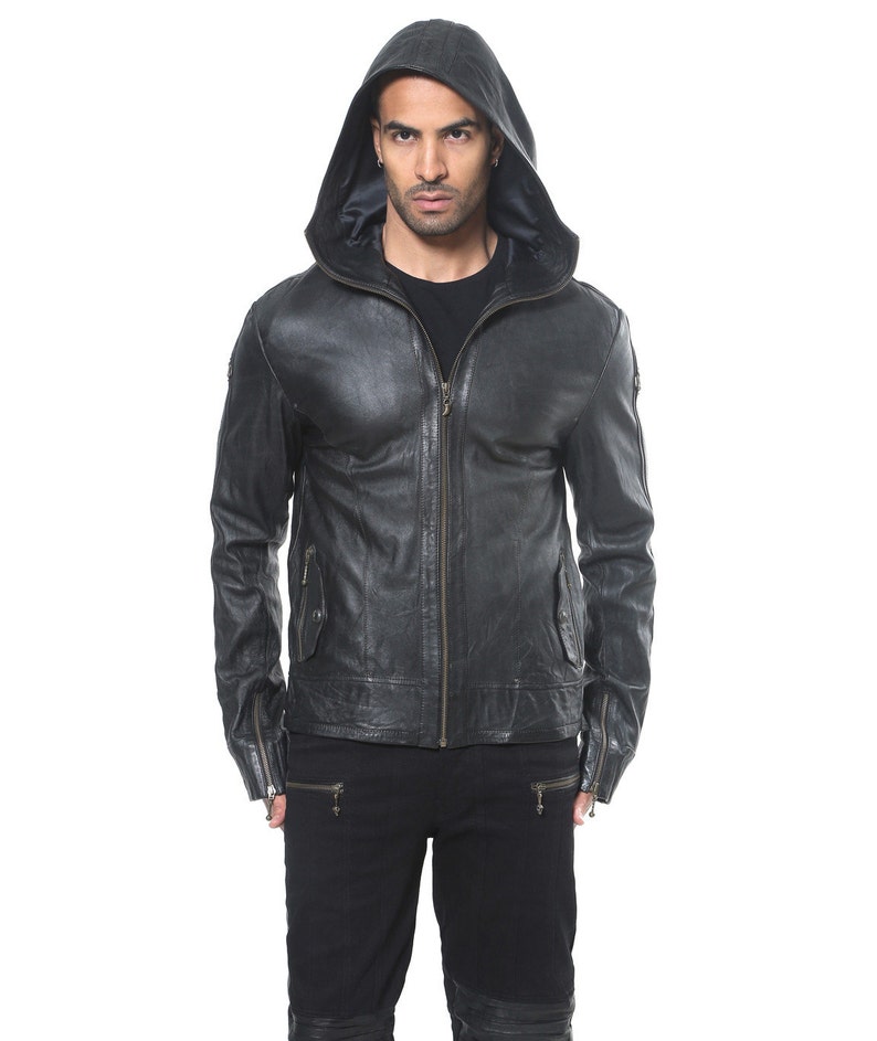 May include: A black leather jacket with a zipper closure and a hood. The jacket has a distressed look and features zippered pockets on the sides.