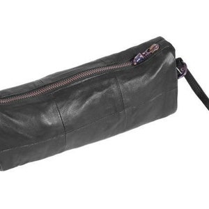 May include: A black leather zippered pouch with a short handle. The pouch is made of stitched leather panels.