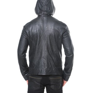 May include: Black leather jacket with a hood. The jacket has a zipper closure and a seam down the back.