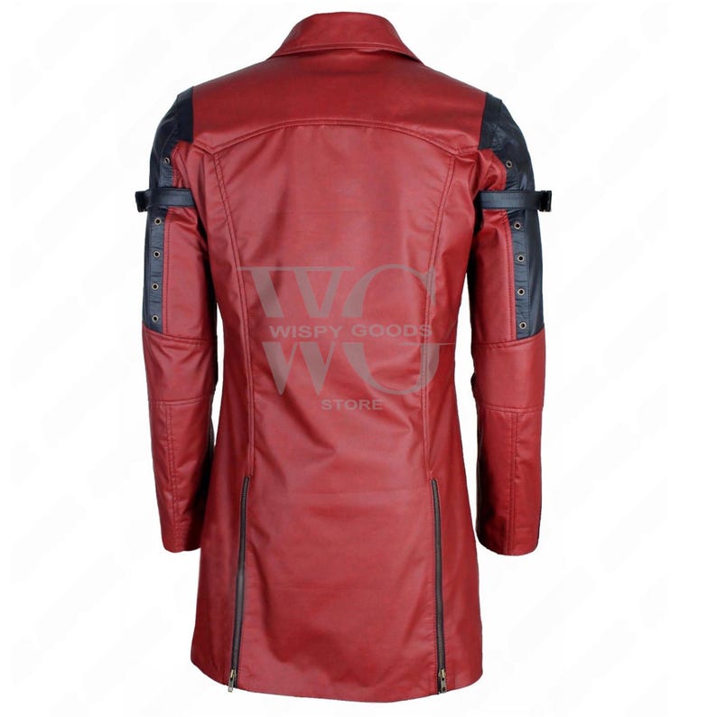 A full-length, front-facing photo of a bold, two-tone real leather trench coat/long jacket in deep red and black. The coat has a dramatic, duster-length cut and features a notched lapel collar. It contrasts red leather on the main body panels with black leather on the shoulders, inner lapels, and portions of the sleeves. The coat is highly detailed with multiple metallic accents, including functional and decorative buckles and straps on the shoulders and cuffs, gothic or rocker aesthetic.