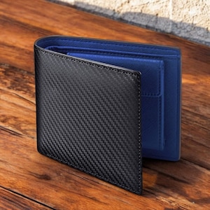 May include: A black leather wallet with a carbon fiber pattern and a blue leather interior.