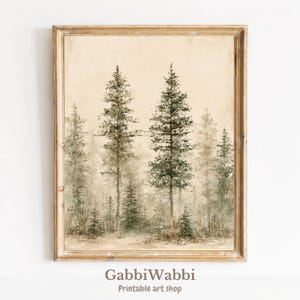 May include: A framed wall art print featuring a muted, painterly forest scene with tall evergreen trees in shades of sage green and brown against a cream-colored background. The text GabbiWabbi Printable art shop is printed at the bottom.