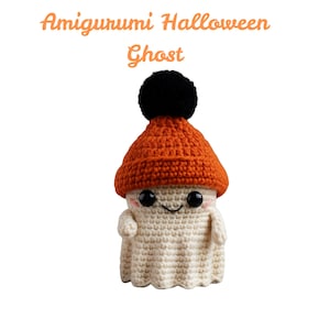 May include: A crocheted ghost doll with a smiling face, wearing an orange hat with a black pom-pom. The text "Amigurumi Halloween Ghost" is at the top. The doll is off-white and has black eyes.