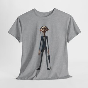May include: Grey t-shirt with a cartoon illustration of a character in a dark blue suit with pinstriped trousers, holding a black umbrella. The character has a pale complexion and a thin build. The design is centered on the shirt.