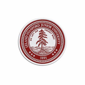 May include: A circular embroidered patch featuring the Leland Stanford Junior University seal in red and white. The design includes a central redwood tree, mountain range, the text Die Luft der Freiheit weht, and the year 1891 at the bottom.