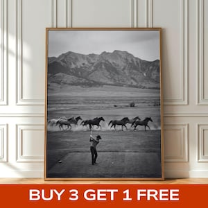 May include: Black and white framed print featuring a golfer swinging a club on a green, with a herd of horses running in the background. Mountains and a field are also visible. The text "BUY 3 GET 1 FREE" is at the bottom.