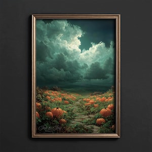 Op de afbeelding: Een ingelijste print met een landschap met een pad dat door een veld met oranje pompoenen leidt onder een dramatische, bewolkte lucht. Het kunstwerk heeft een vintage esthetiek, met de tekst "Ink & Joy Print Co." in de linker benedenhoek.