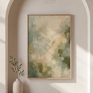 May include: A rectangular framed wall art piece featuring an abstract painting with blended shades of sage green, cream, and beige. The artwork displays a subtle, light-colored bird silhouette in the center. The text FRAMED GRACE appears above.