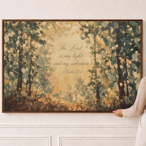 May include: A rectangular wall art piece in a dark wood frame featuring an impressionistic forest scene with golden light filtering through trees. The text reads: The Lord is my light and my salvation—Psalm 27:1, centered in a soft, glowing yellow hue.