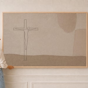 May include: A rectangular wall art piece in a light wood frame featuring a minimalist line drawing of a figure on a cross. The artwork is set against a muted, textured beige background with abstract shapes and soft, earthy brown color tones.
