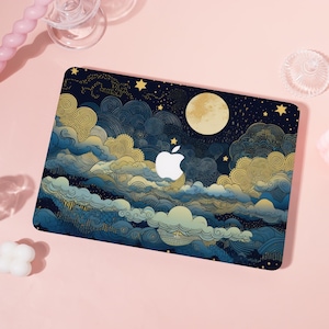 May include: A laptop case featuring a night sky design with a full moon, stars, and stylized clouds in shades of blue and gold. The Apple logo is prominently displayed in white. The case has a glossy finish.