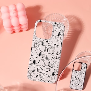 May include: A white smartphone case featuring a repeating black line art pattern of the character Snoopy in various poses. The design includes multiple illustrations of the dog sitting, lying down, and holding a heart, covering the entire surface.