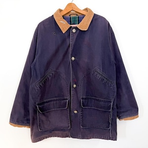 May include: A navy blue jacket with a brown corduroy collar and two large front pockets. The jacket has a button-up closure and a plaid lining visible at the collar. The cuffs are trimmed with brown fabric. The jacket is hanging on a wooden hanger.
