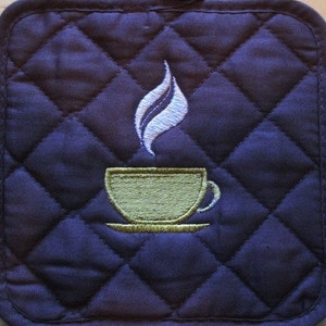 May include: A dark blue quilted hot pad with a white embroidered design of a steaming cup of coffee.