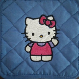 May include: Blue quilted hot pad with an embroidered Hello Kitty design. Hello Kitty is wearing a pink dress and a red bow.