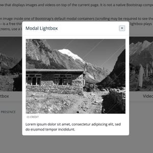 May include: Black and white image of a stone building with multiple windows, set against a backdrop of towering mountains. The text "Modal Lightbox" is at the top, with additional text below.