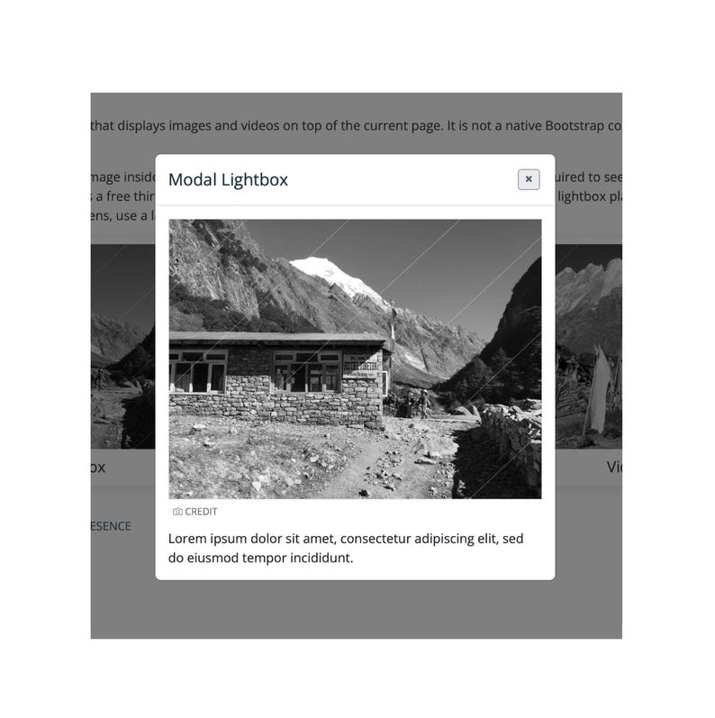 May include: A black and white image of a mountain landscape is displayed within a modal lightbox. The lightbox has a close button and displays the text "Modal Lightbox". Below the image is the text "Lorem ipsum dolor sit amet, consectetur adipiscing elit, sed do eiusmod tempor incididunt."