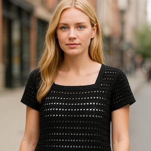 May include: A black, short-sleeved crochet top with a square neckline. The top features a horizontal openwork design and is worn with blue denim jeans. The image is taken outdoors.