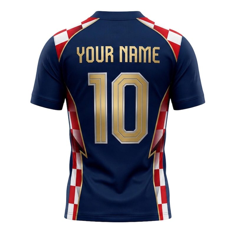 May include: Navy blue short-sleeve jersey with gold lettering and numbers. The jersey features the text "YOUR NAME" above the number "10". Red and white checkered pattern accents the shoulders and sides. A sports-themed apparel item.