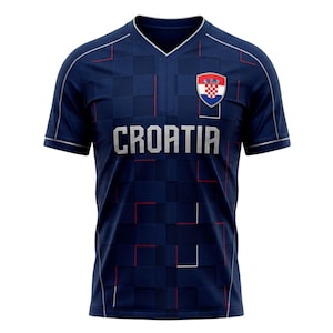 May include: Navy blue Croatia soccer jersey with a textured pattern. The jersey features the word "CROATIA" in silver letters across the chest, along with the Croatian coat of arms. Red and white accents are visible.