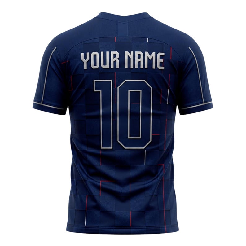 May include: Navy blue athletic jersey with the text "YOUR NAME" and the number "10" in silver. The jersey has a grid pattern with red accents. The sleeves and collar are trimmed in silver.