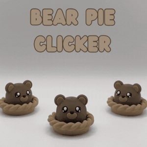 May include: Three brown bear heads emerging from tan, braided-edge pie crusts. The text BEAR PIE CLICKER is displayed in large, rounded, light brown letters above the three bear figures, which feature dark eyes and small, rounded ears.