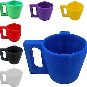 May include: A collection of colorful, textured mugs in various colors including green, purple, yellow, red, black, white, and blue. Each mug has a distinctive handle and a slightly tapered shape, suitable for beverages.