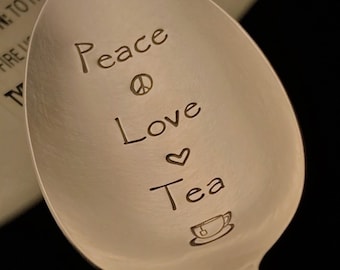 May include: A silver spoon with the words "Peace Love Tea" engraved on the bowl. A peace sign, heart, and a small teacup are also engraved on the spoon.