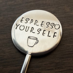 May include: Silver stirring spoon with a round handle that says "Espresso Yourself" with a small coffee cup icon.