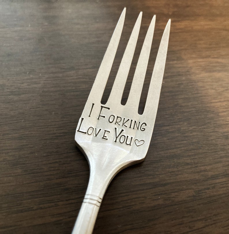 May include: A silver fork with the words "I Forking Love You" engraved on it.