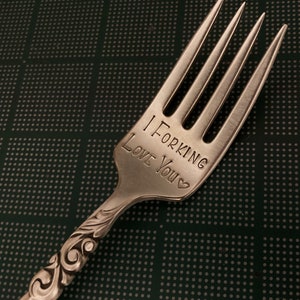 May include: A silver fork with an engraved message that reads "I Forking Love You".