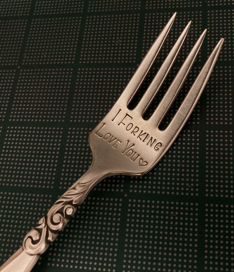 May include: A silver fork with an engraved message that reads "I Forking Love You".