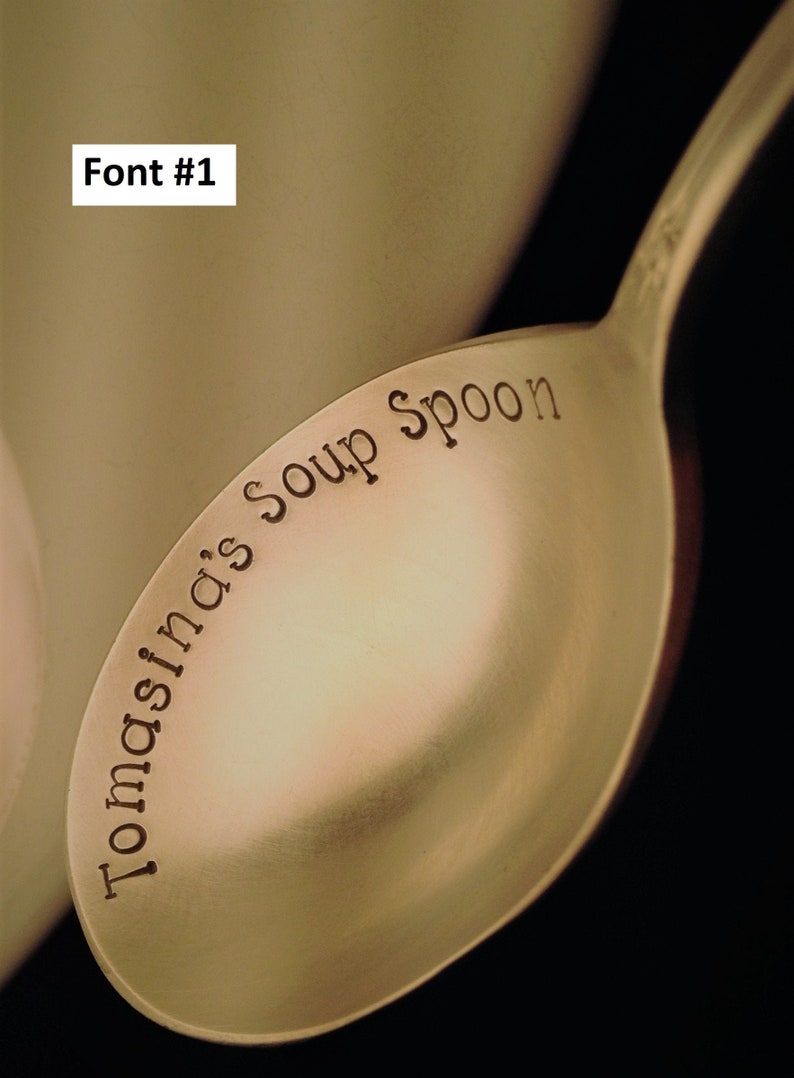 May include: A gold-colored soup spoon with the words "Tomasina's Soup Spoon" engraved on the bowl.