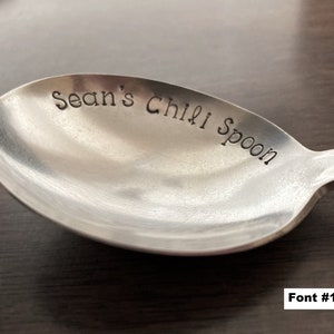 May include: A silver spoon with the words "Sean's Chili Spoon" engraved on the front.