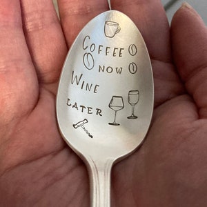 May include: A silver spoon with the text "Coffee Now Wine Later" engraved on it. The spoon also has a small coffee cup, coffee bean, wine glass, and corkscrew engraved on it.