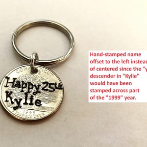 May include: A silver keychain with a coin pendant. The coin is stamped with "Happy 25th Kylie" and the year 1999. The text is in black, and the coin has a tree design. The keychain is a personalized gift.