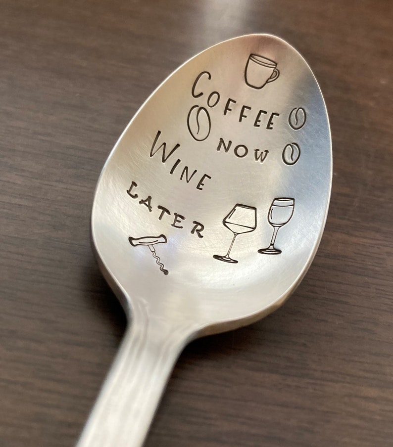 May include: Silver spoon with the text "Coffee Now Wine Later" engraved on it. The spoon also has a coffee cup, coffee beans, wine glasses, and a corkscrew engraved on it.