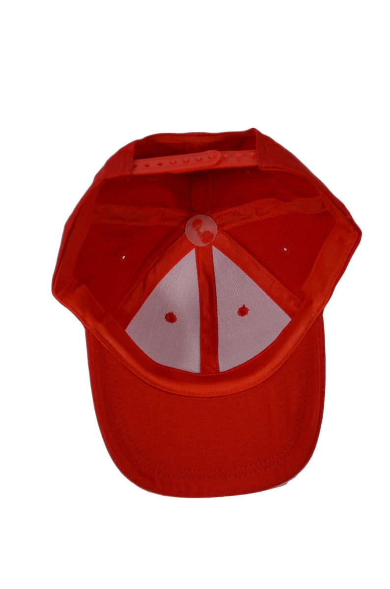 May include: A red baseball cap with a white mesh lining and a strap closure. The cap is turned inside out, showing the interior.