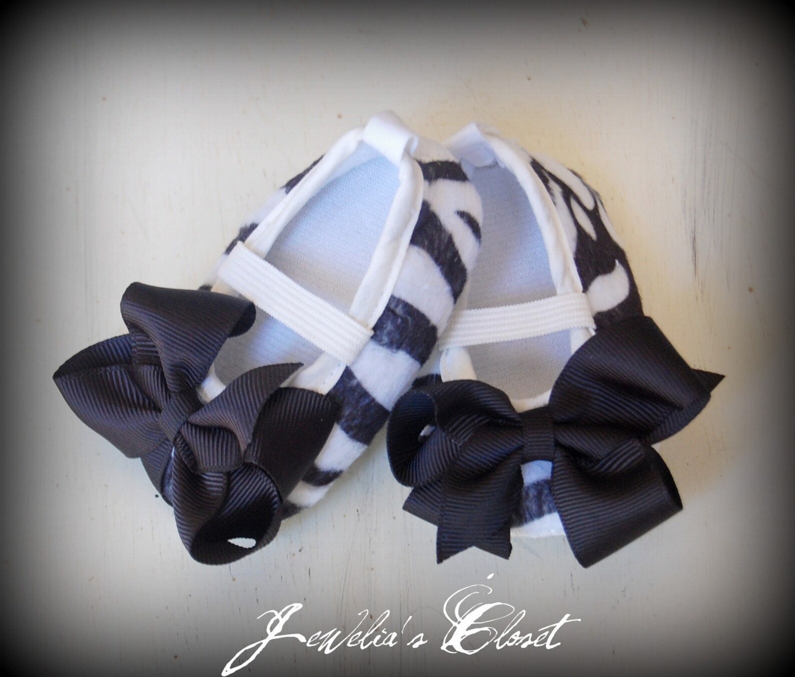 black and white zebra print ballet flat baby shoes with black grosgrain bows