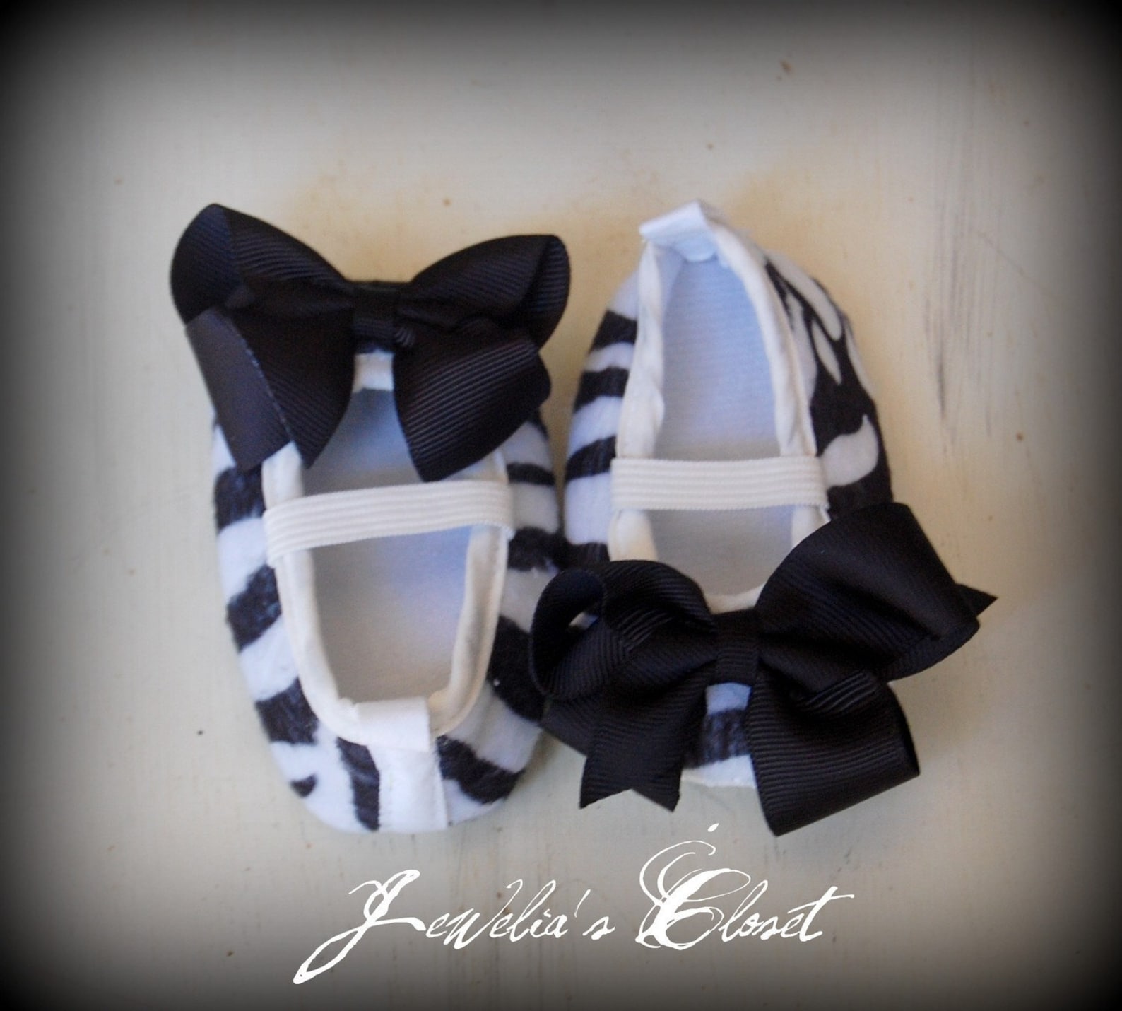 black and white zebra print ballet flat baby shoes with black grosgrain bows