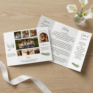 Peut inclure: Un programme de service commémoratif blanc avec des photos, du texte et une illustration de colombe. Le programme comprend une nécrologie, l'ordre du service et un message de remerciement. Des accents de feuilles vertes et un ruban blanc sont également présents.