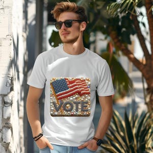 May include: White t-shirt with a graphic of an American flag made of pearls and the word "VOTE" in gold letters.