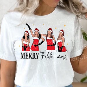 May include: White t-shirt featuring a graphic of four figures in red Santa outfits with black gloves. The text "MERRY Fetch-mas!" is printed below the figures. Gold stars are scattered around the figures.